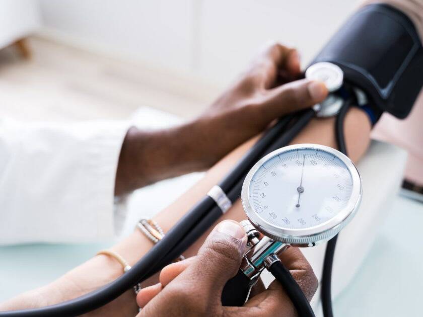 Know your numbers - Doctor using a stethoscope to measure patient's blood pressure, highlighting PreCardix's commitment to cardiovascular health.
