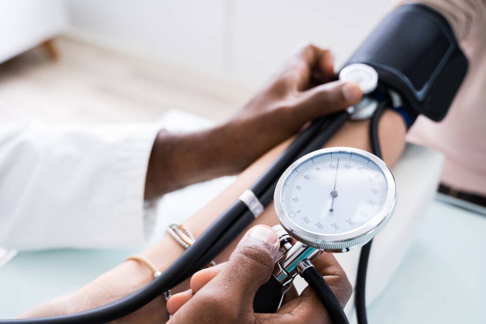 Know your numbers - Doctor using a stethoscope to measure patient's blood pressure, highlighting PreCardix's commitment to cardiovascular health.