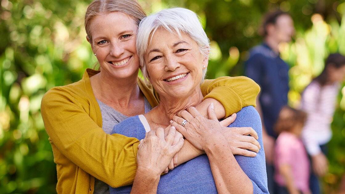 Heart Wellness PreCardix® - A smiling mother and daughter posing together outdoors at a park.