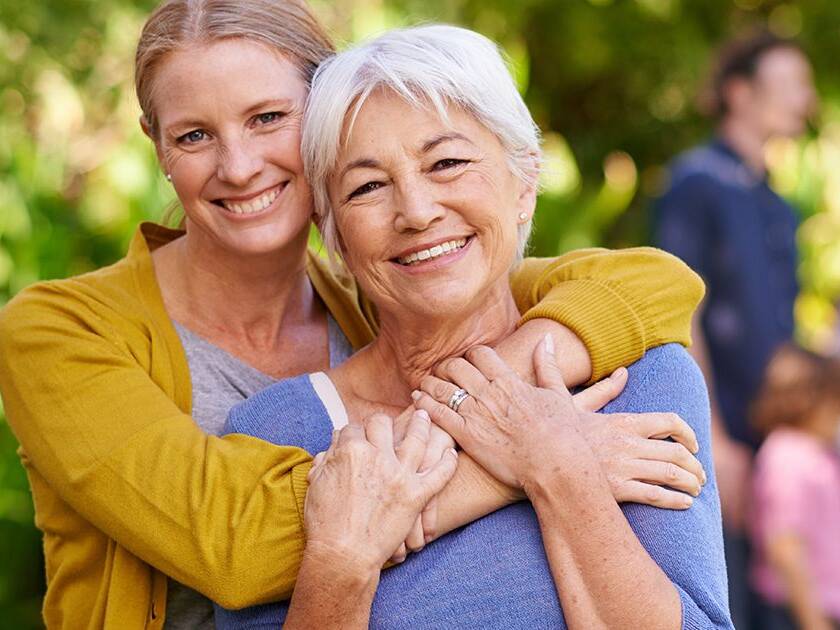 Heart Wellness PreCardix® - A smiling mother and daughter posing together outdoors at a park.