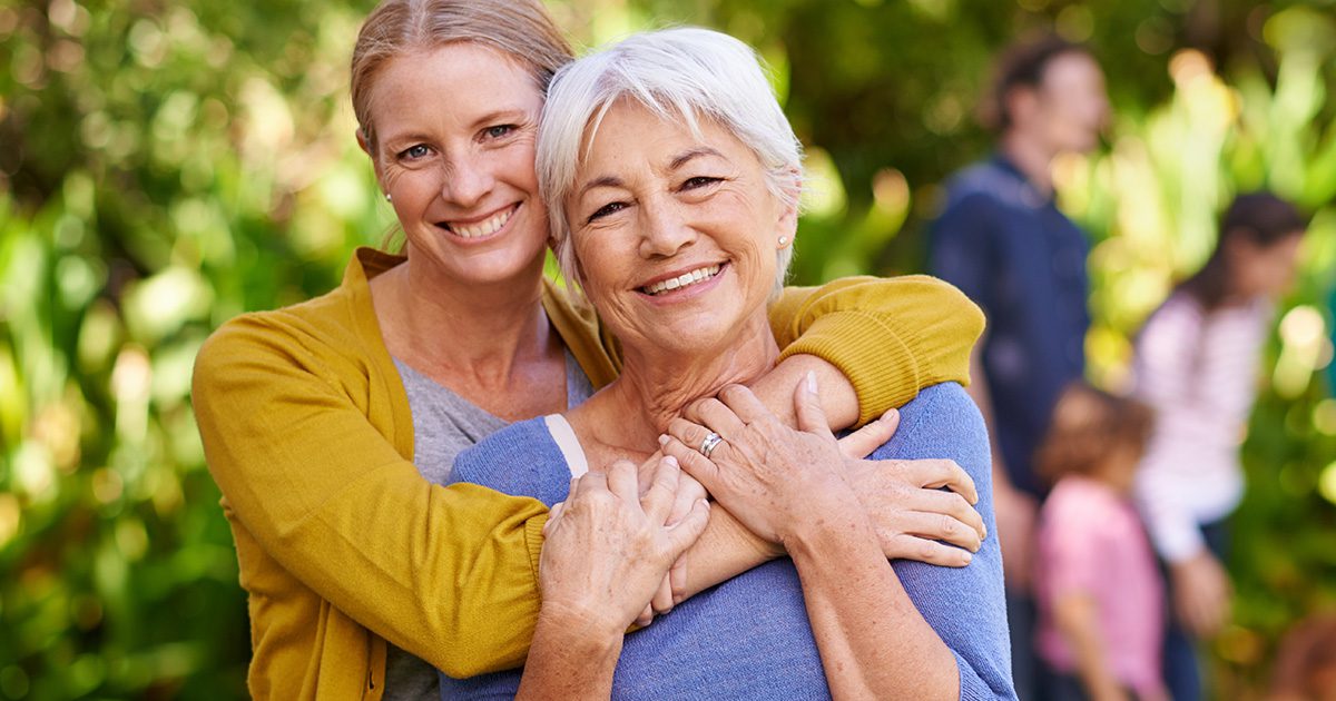 Heart Wellness PreCardix® - A smiling mother and daughter posing together outdoors at a park.