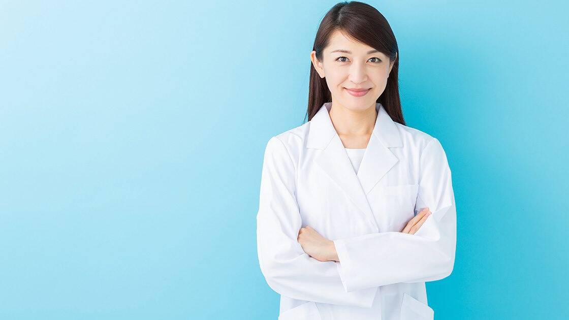 Heart Health Supplements: Female scientist in lab attire smiling at the camera, with a light blue to white gradient background.