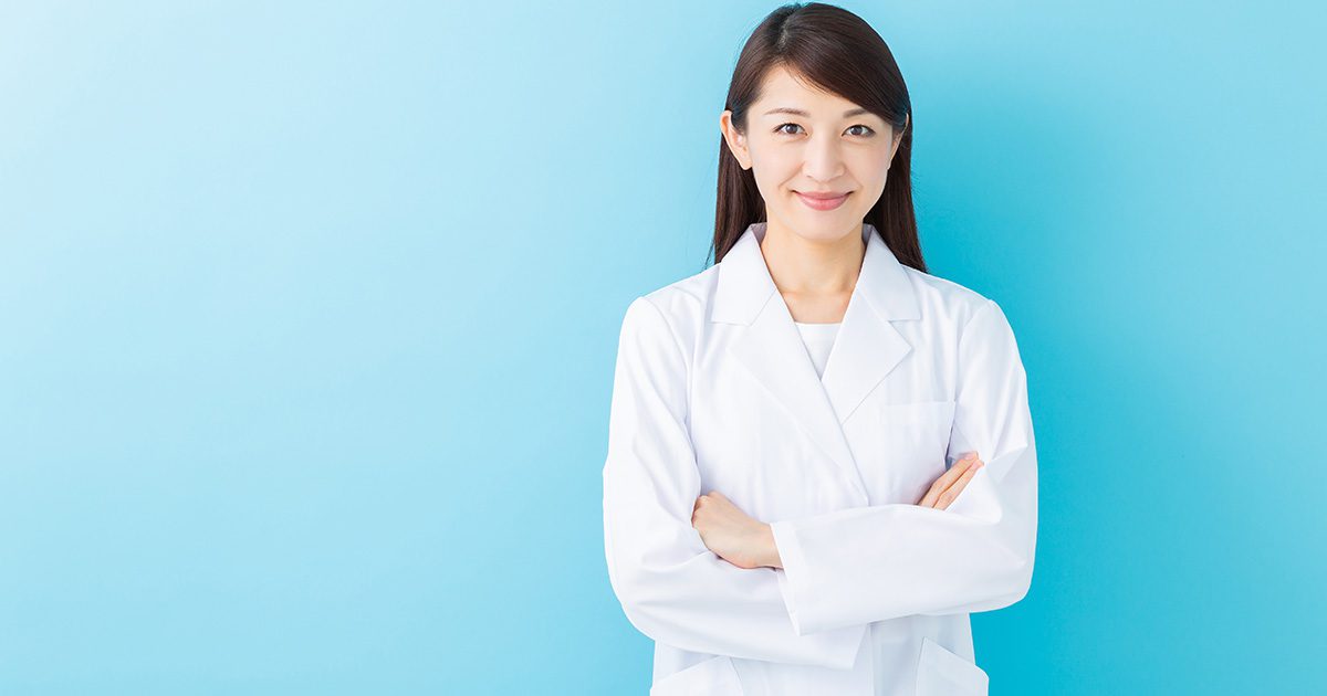 Heart Health Supplements: Female scientist in lab attire smiling at the camera, with a light blue to white gradient background.